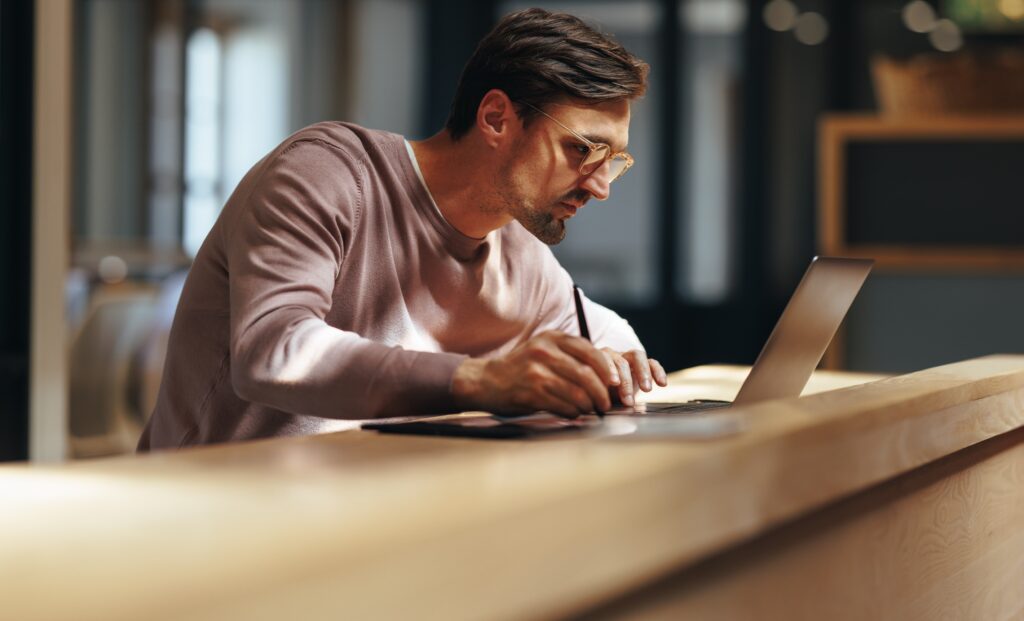 Man working remotely on laptop.