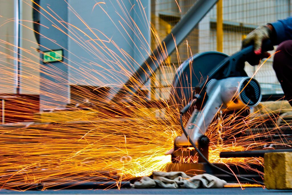 Construction worker using angle grinder